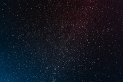 A vast expanse of the night sky filled with countless stars twinkling against a dark backdrop, creating a sense of depth and infinity.