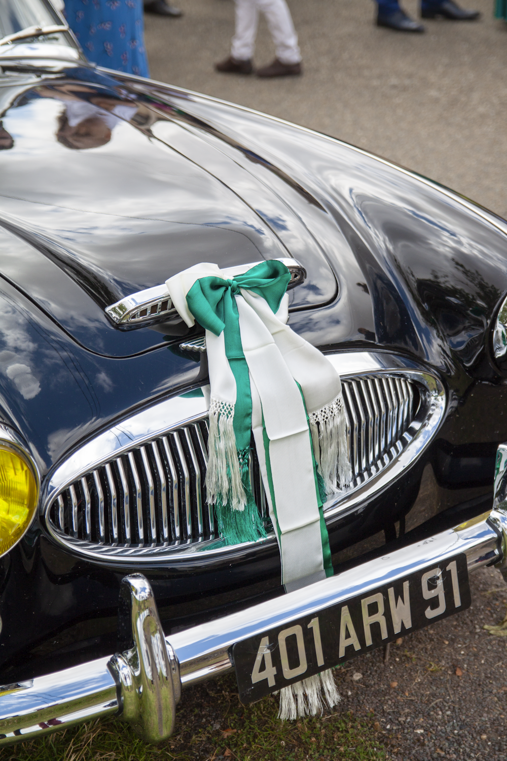 black mercedes benz car with green ribbon