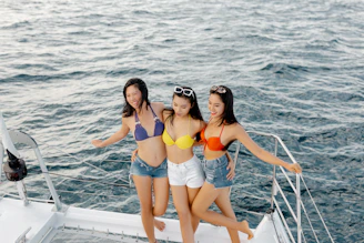 2 women in blue bikini posing for photo