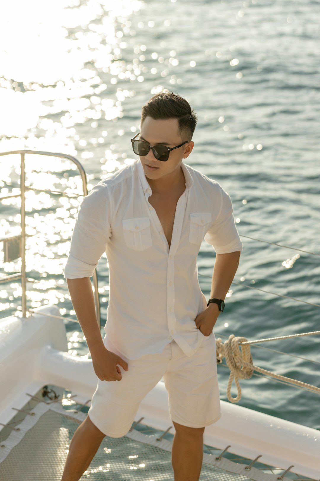 woman in white button up shirt wearing black sunglasses standing on white boat during daytime