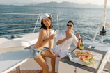 Guests relaxing with wine and tapas on a yacht terrace