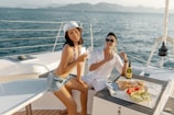 Guests enjoying a laid-back moment with drinks and snacks on the Fenix during a sunny day.