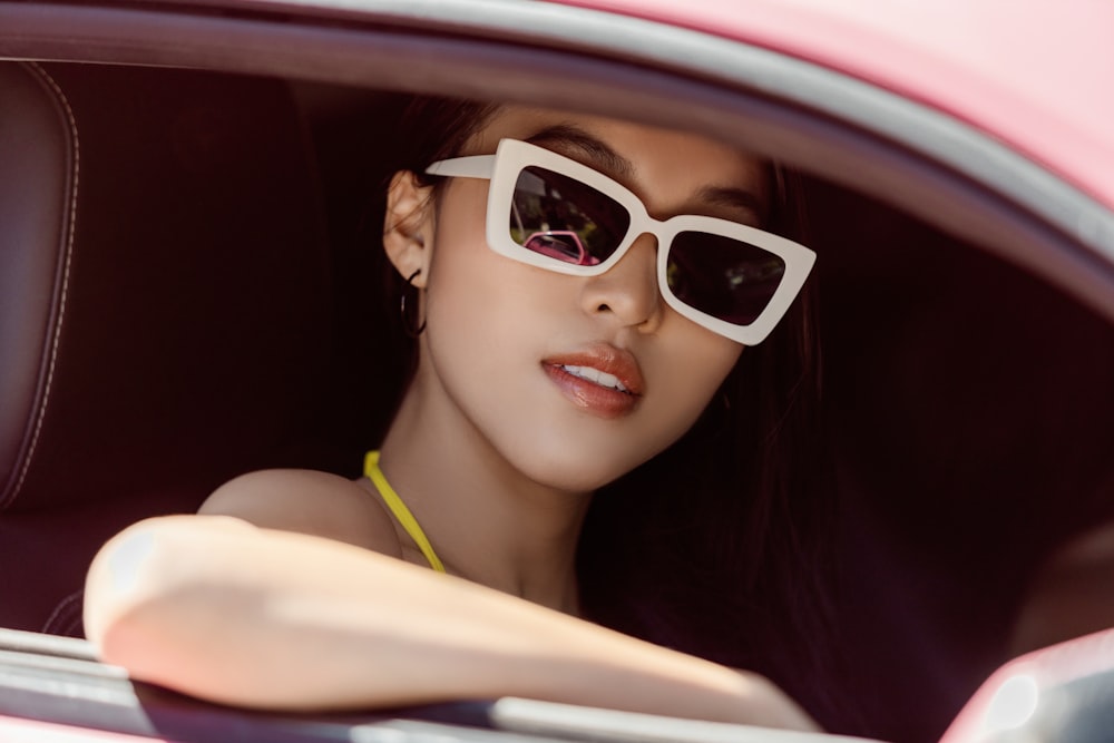 woman in green tank top wearing white framed sunglasses