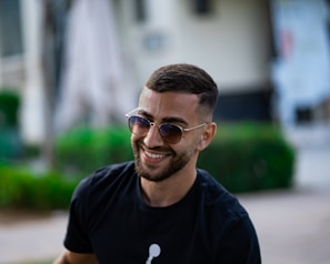 man in black crew neck t-shirt wearing sunglasses