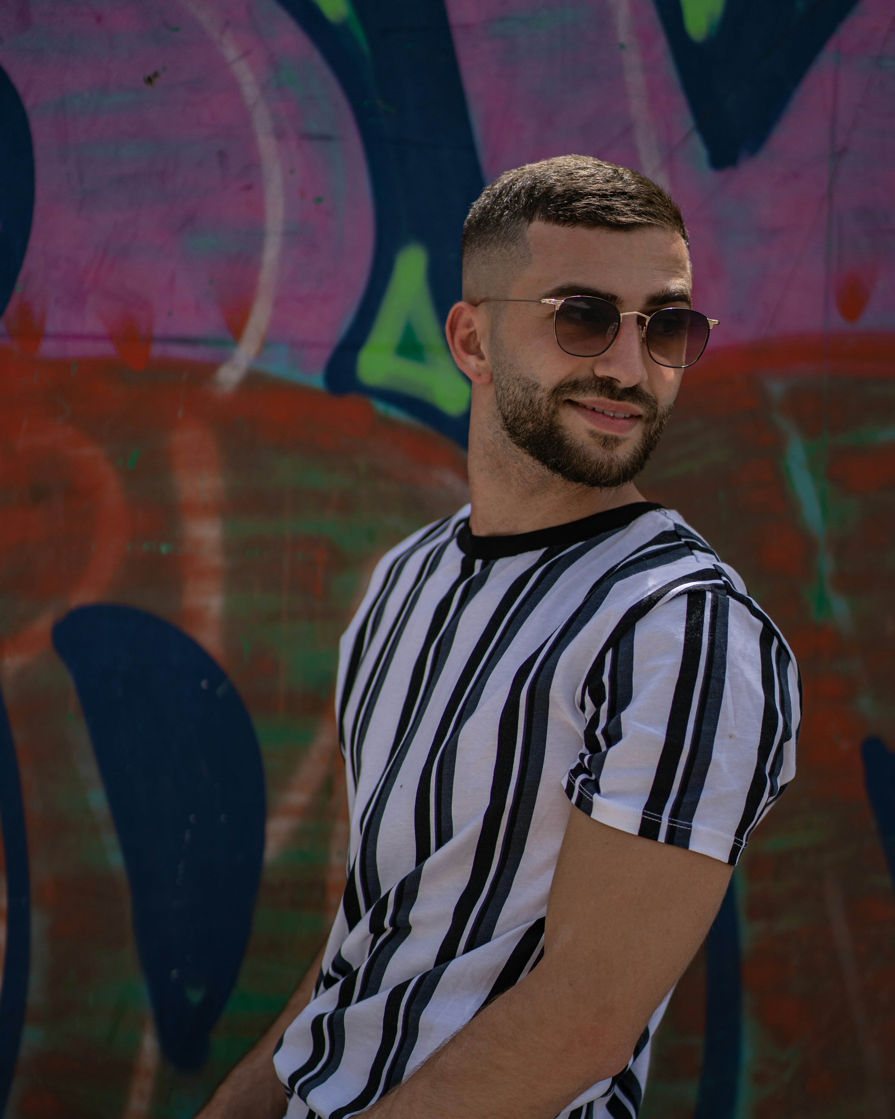 man in black and white striped crew neck t-shirt wearing black sunglasses