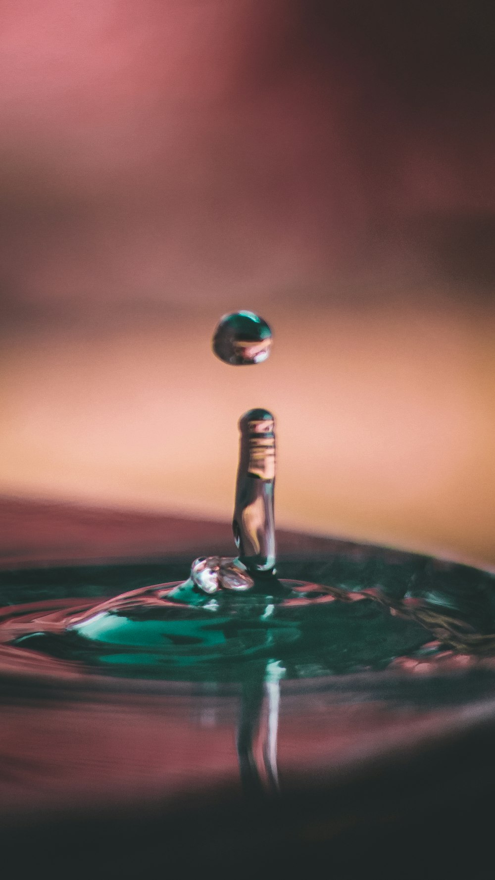 water drop on water in close up photography