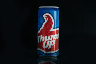 a can of thunder up soda on a black background