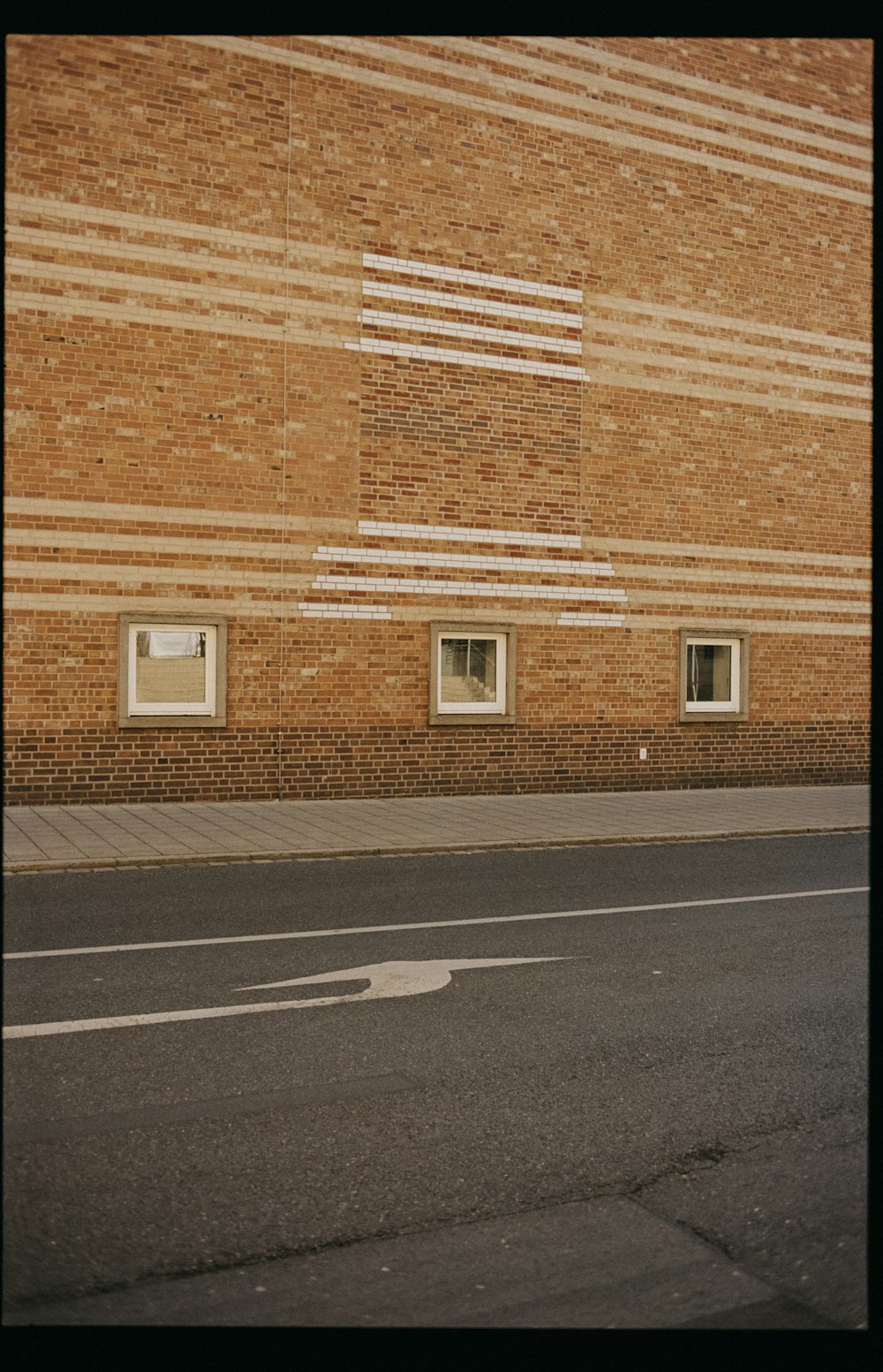 brown brick building beside road