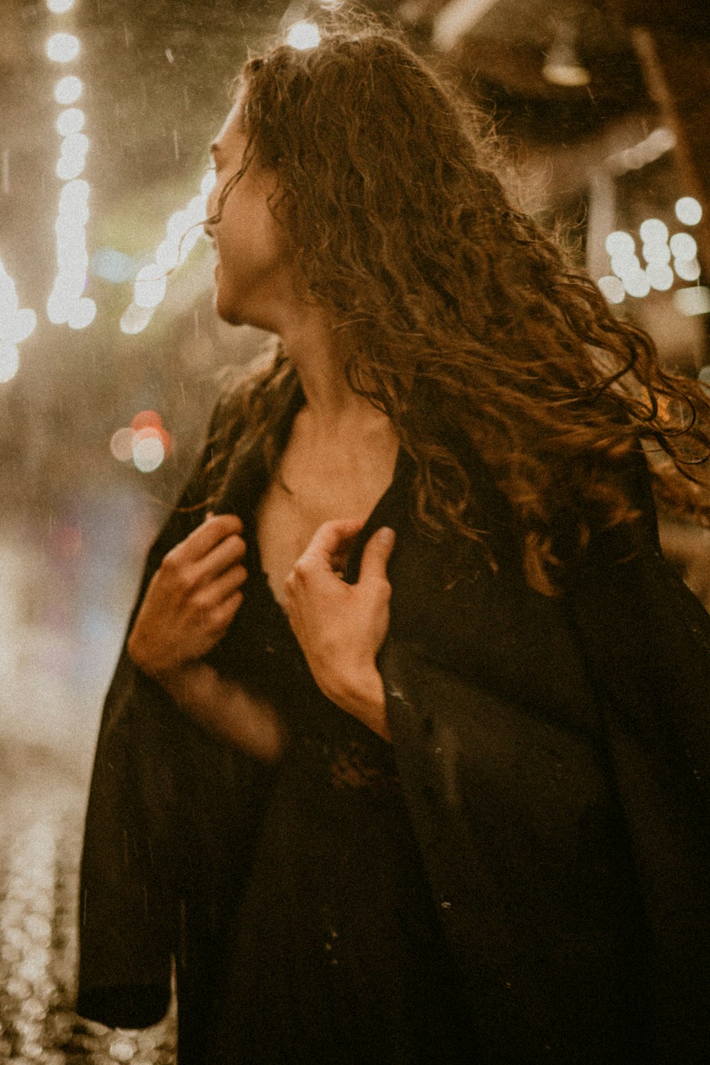 woman in black coat standing