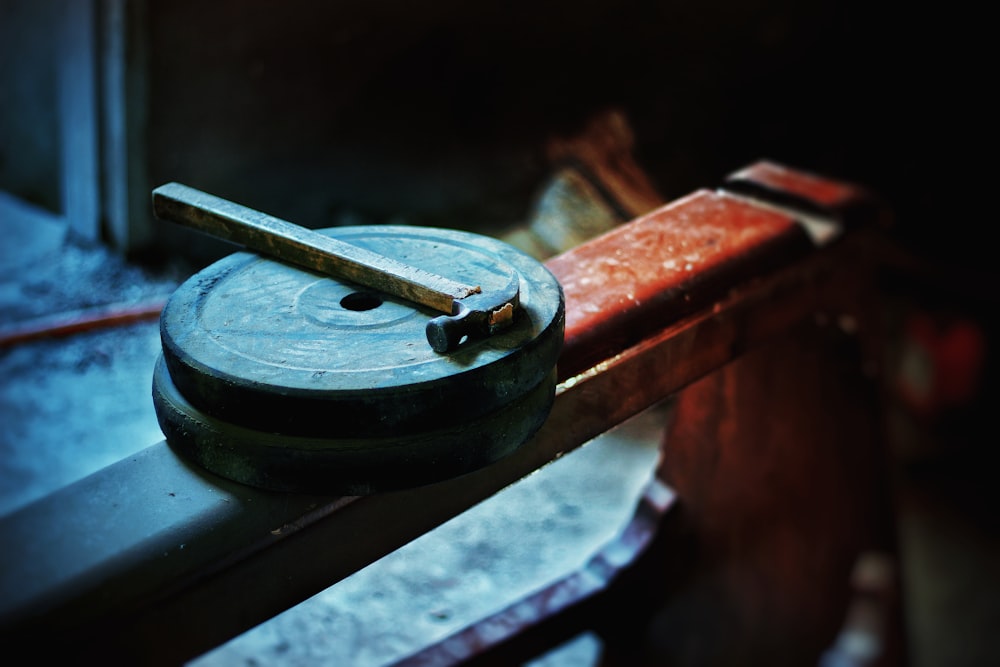 black round metal tool on brown wooden table