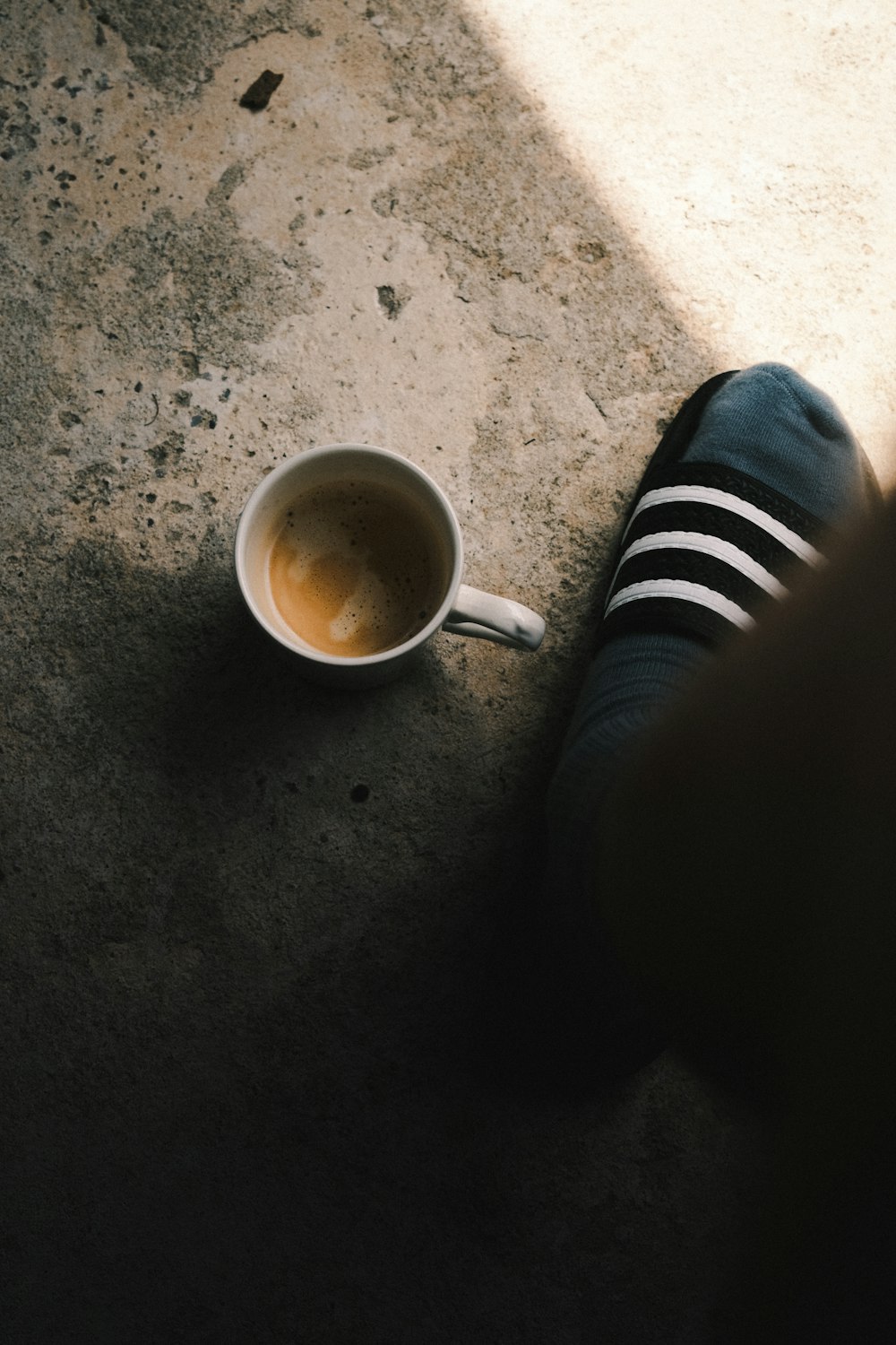 person in black pants and black and white striped socks