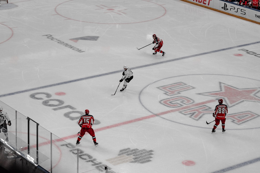 man in red and white hockey jersey playing hockey