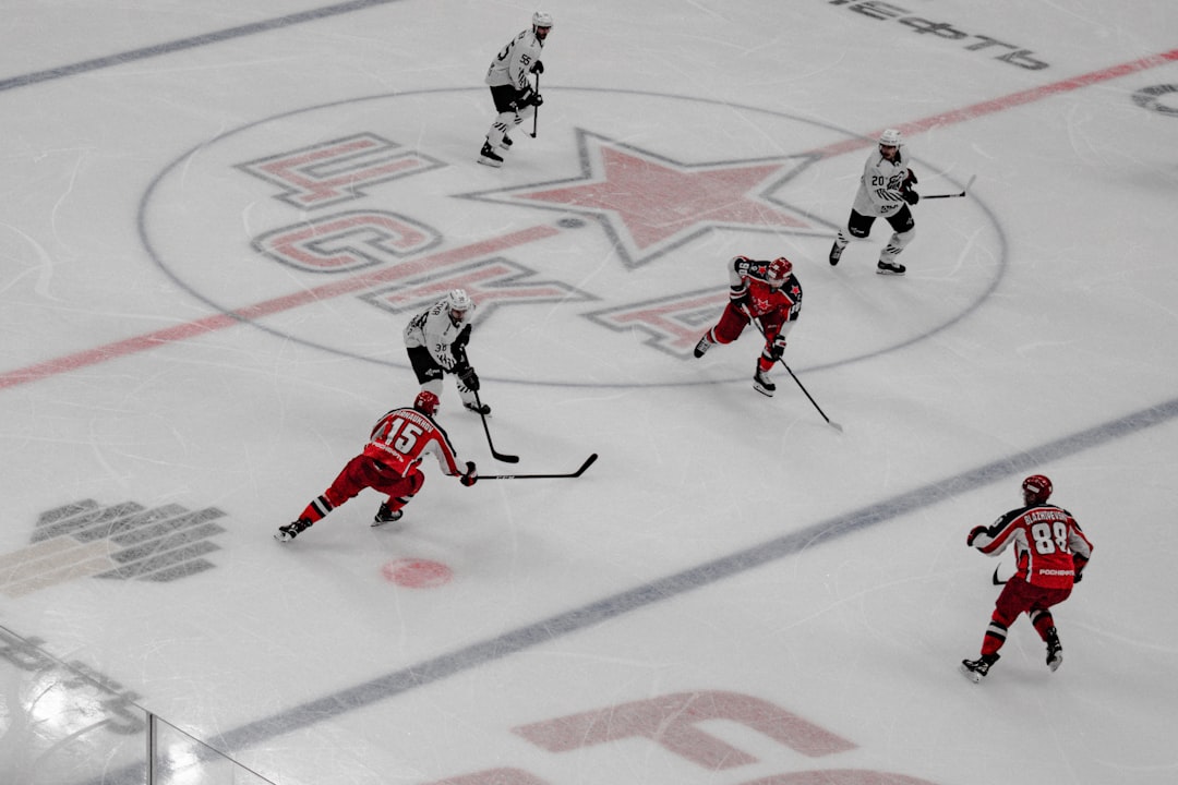 people playing ice hockey on ice field