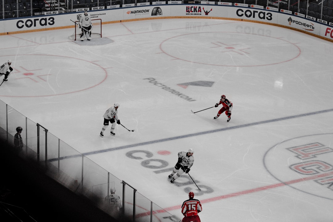 people playing ice hockey on ice field