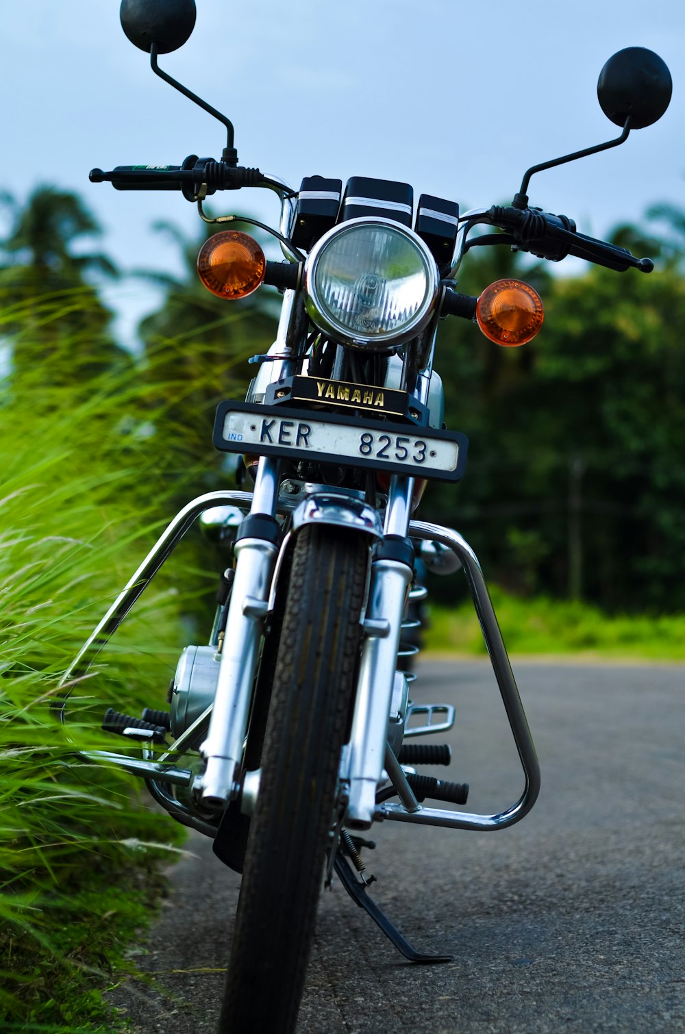 black motorcycle parked on green grass field during daytime