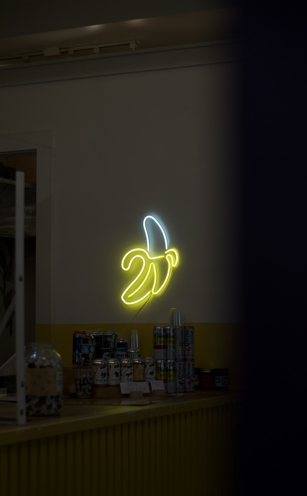 a neon sign that is on the side of a wall