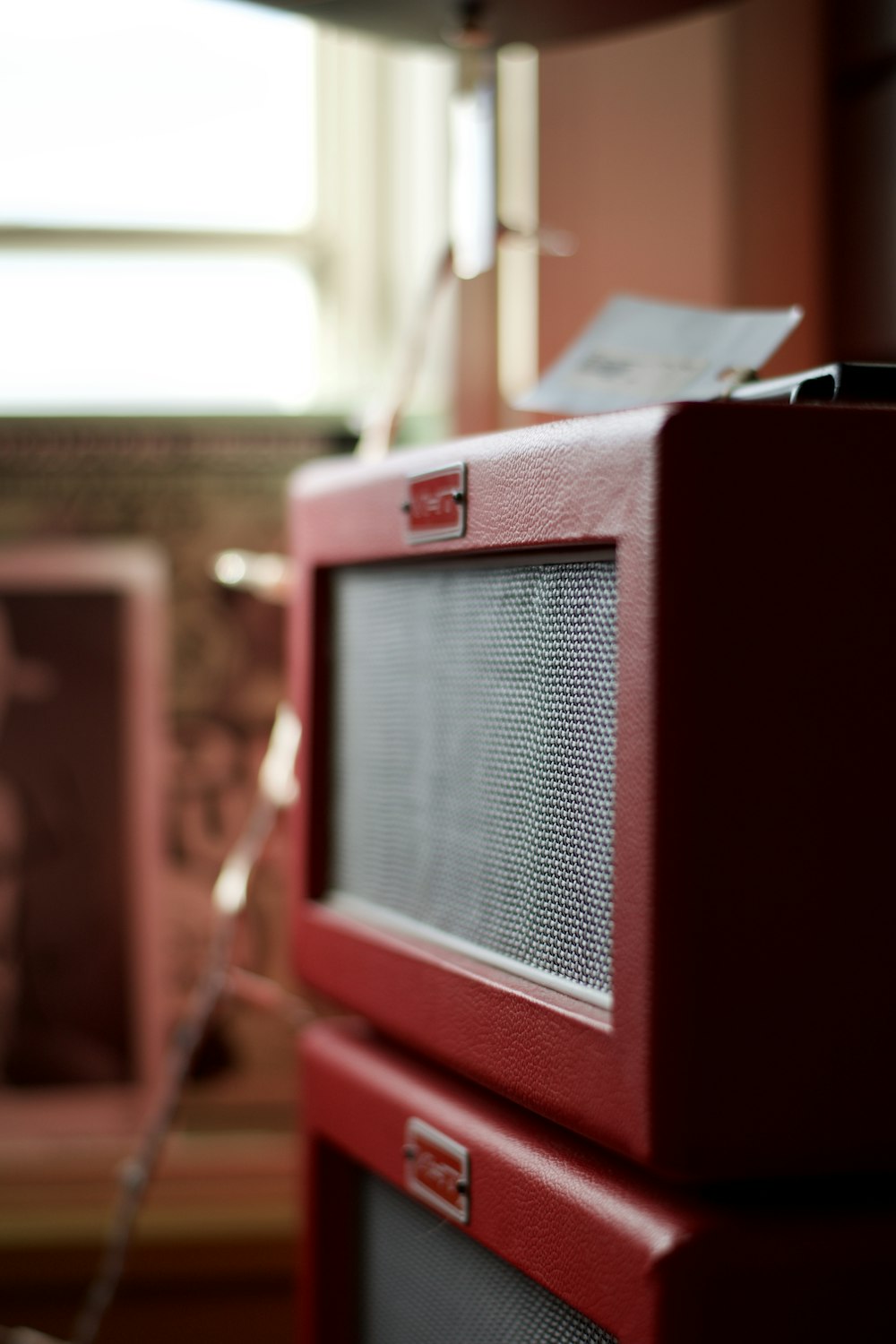 a red radio sitting on top of a wooden table