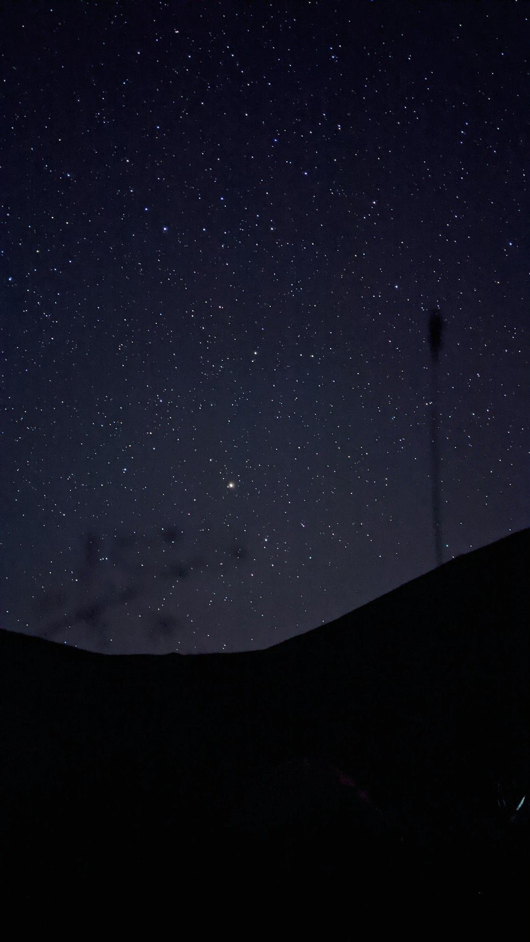 silhouette of mountain under starry night