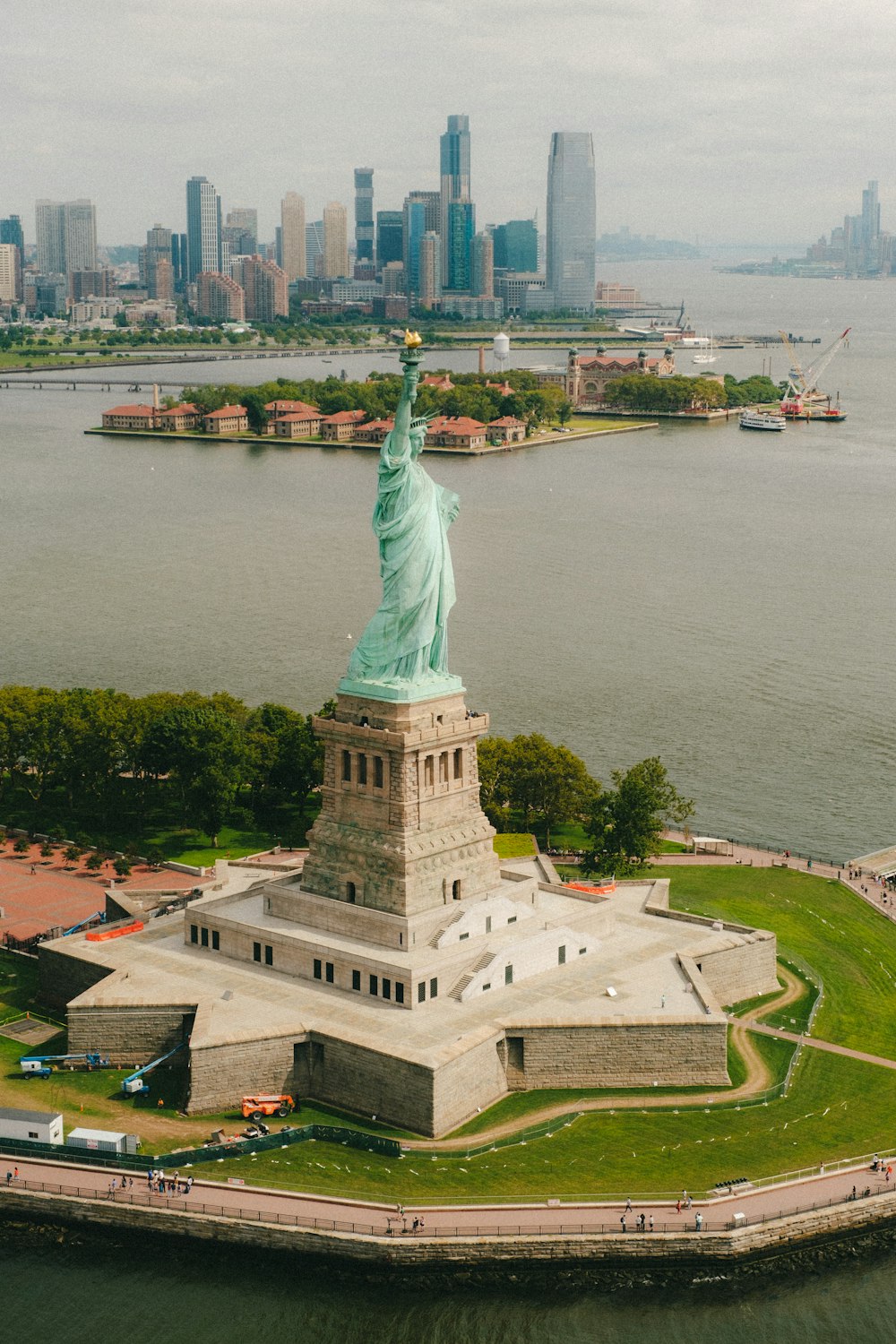statue of liberty near body of water during daytime