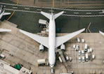 white and blue airplane on airport during daytime