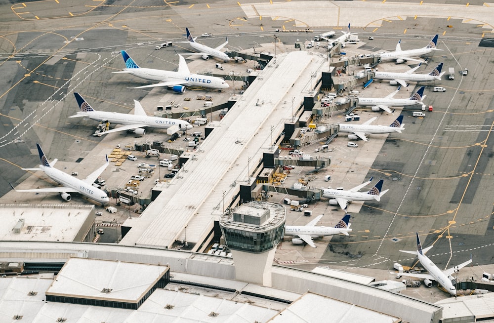 white and gray airplane on airport during daytime