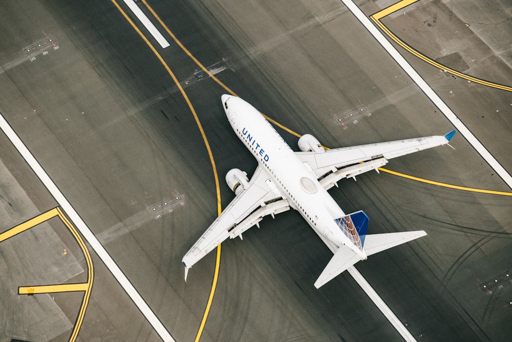 weißes und blaues Flugzeug tagsüber am Flughafen