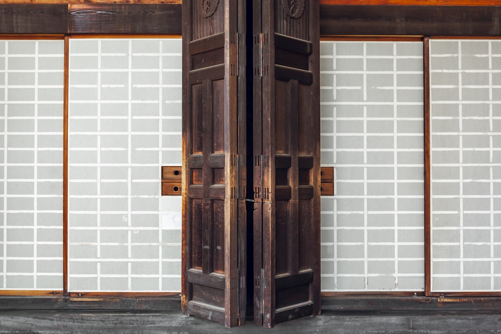 brown wooden door with white wall