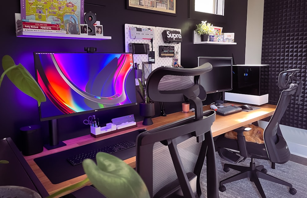 black flat screen computer monitor on brown wooden desk