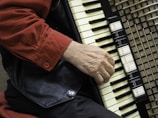 person in red shirt playing piano