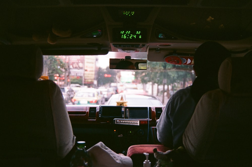 man in white dress shirt driving car during daytime