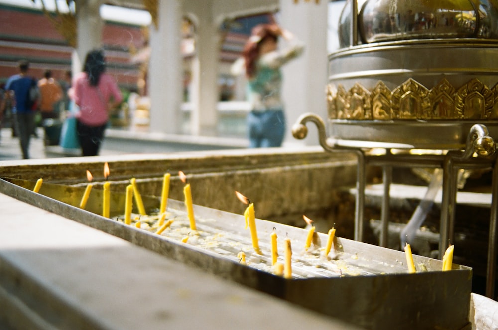 yellow candles on gold holder