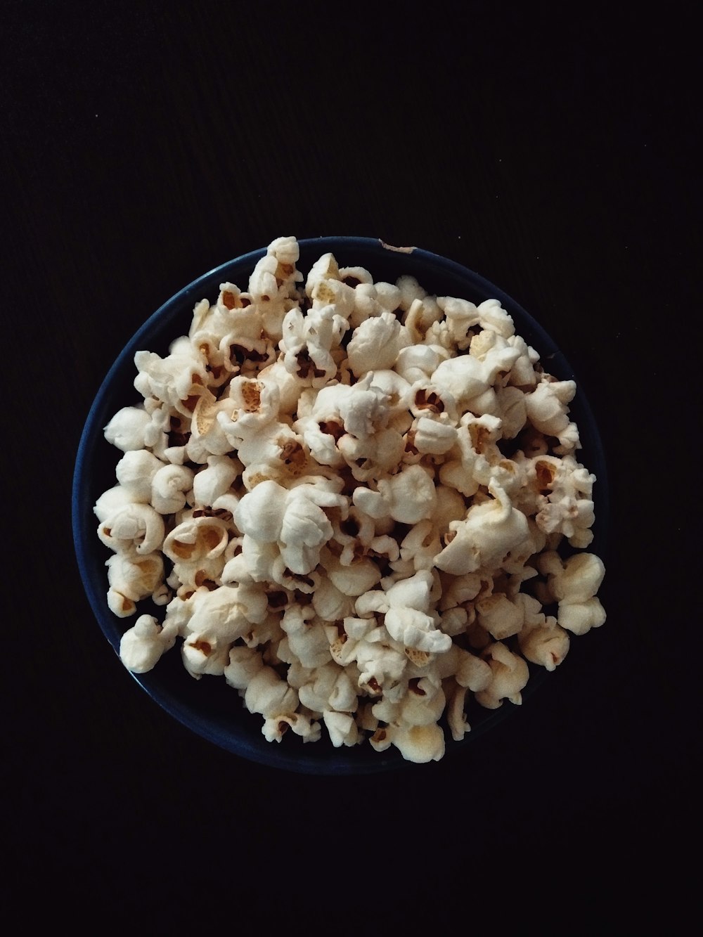popcorn on blue ceramic bowl