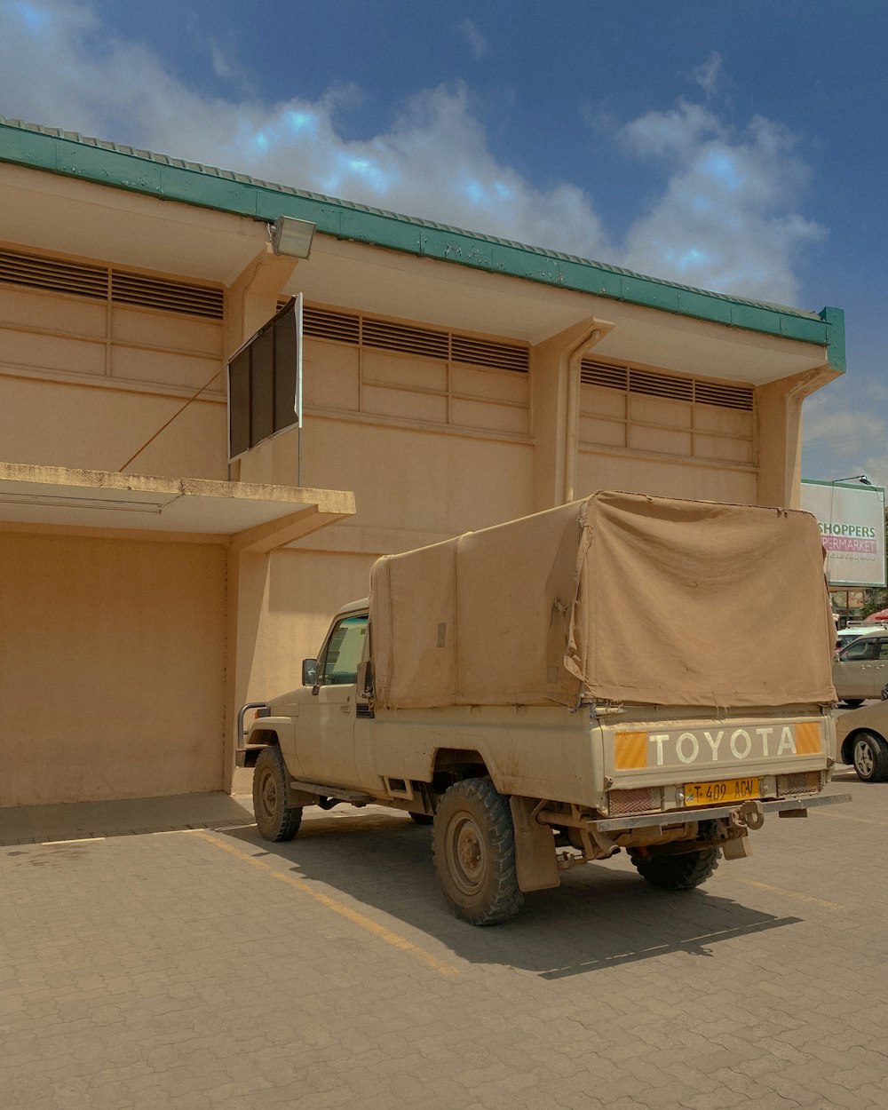 brown utility truck parked beside brown building