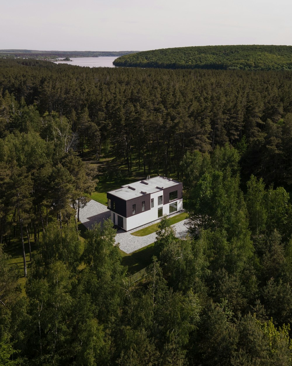 an aerial view of a house surrounded by trees