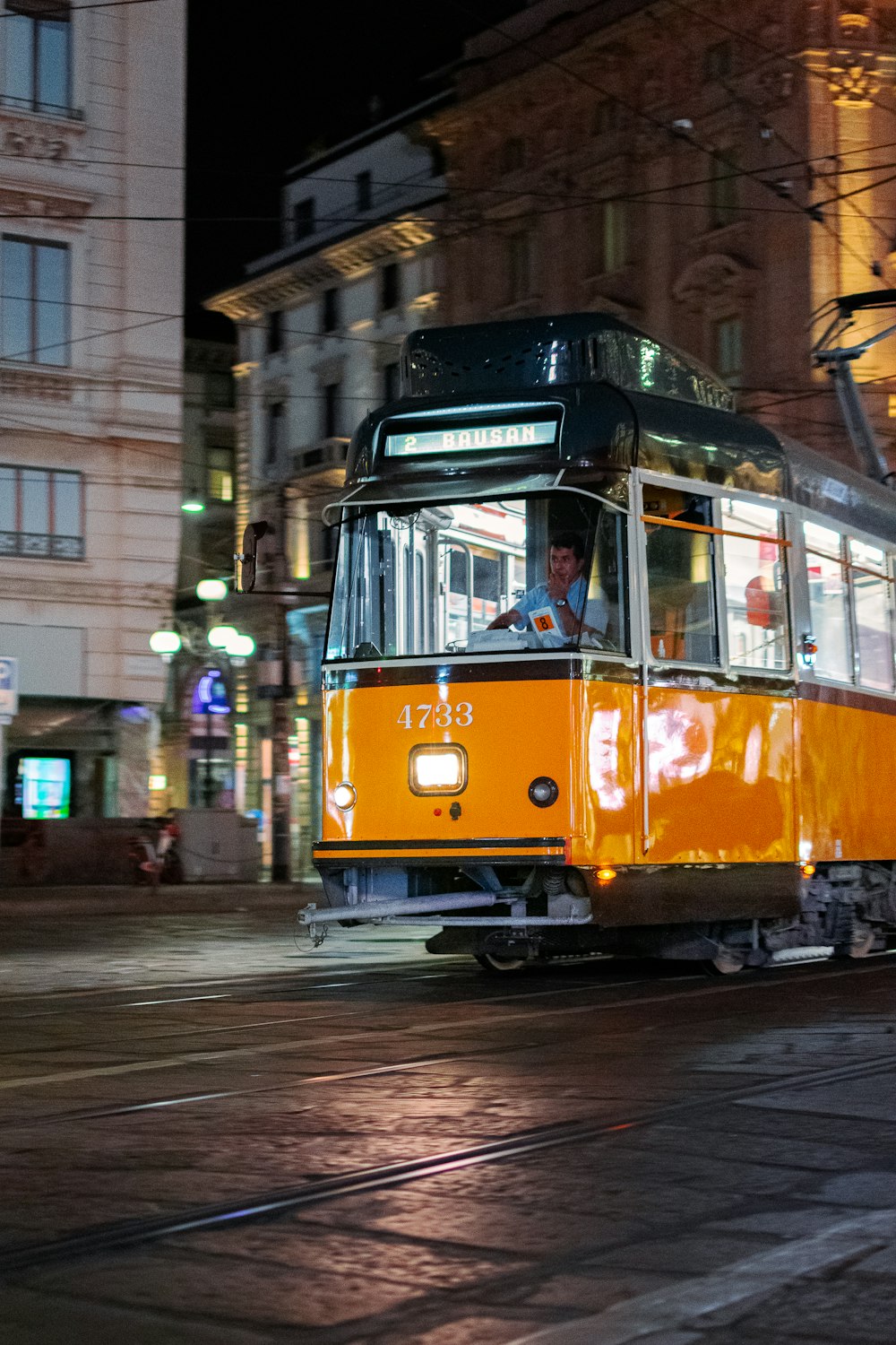 yellow and black tram on road during night time