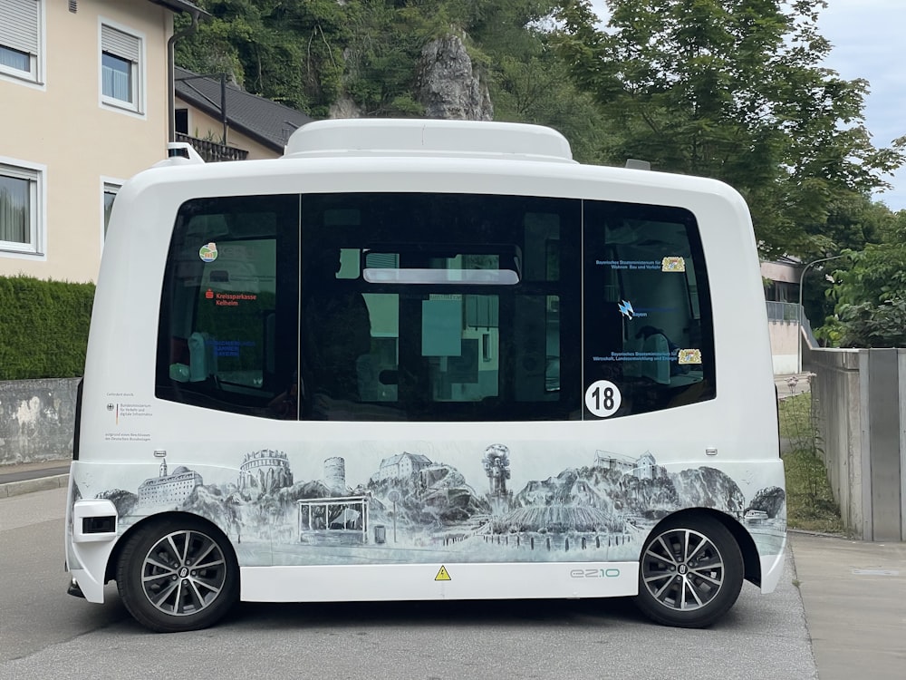 a white bus parked on the side of a road