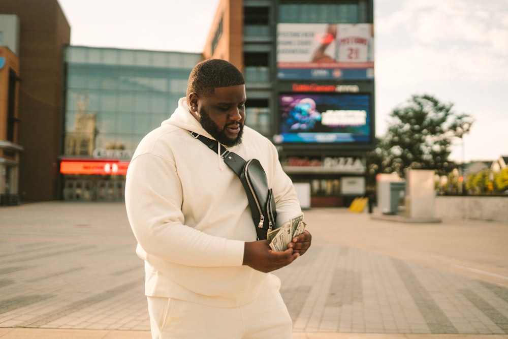 man in white coat holding brown round ornament