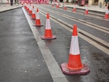Experienced workers placing traffic cones and barriers on a highway for safe traffic flow