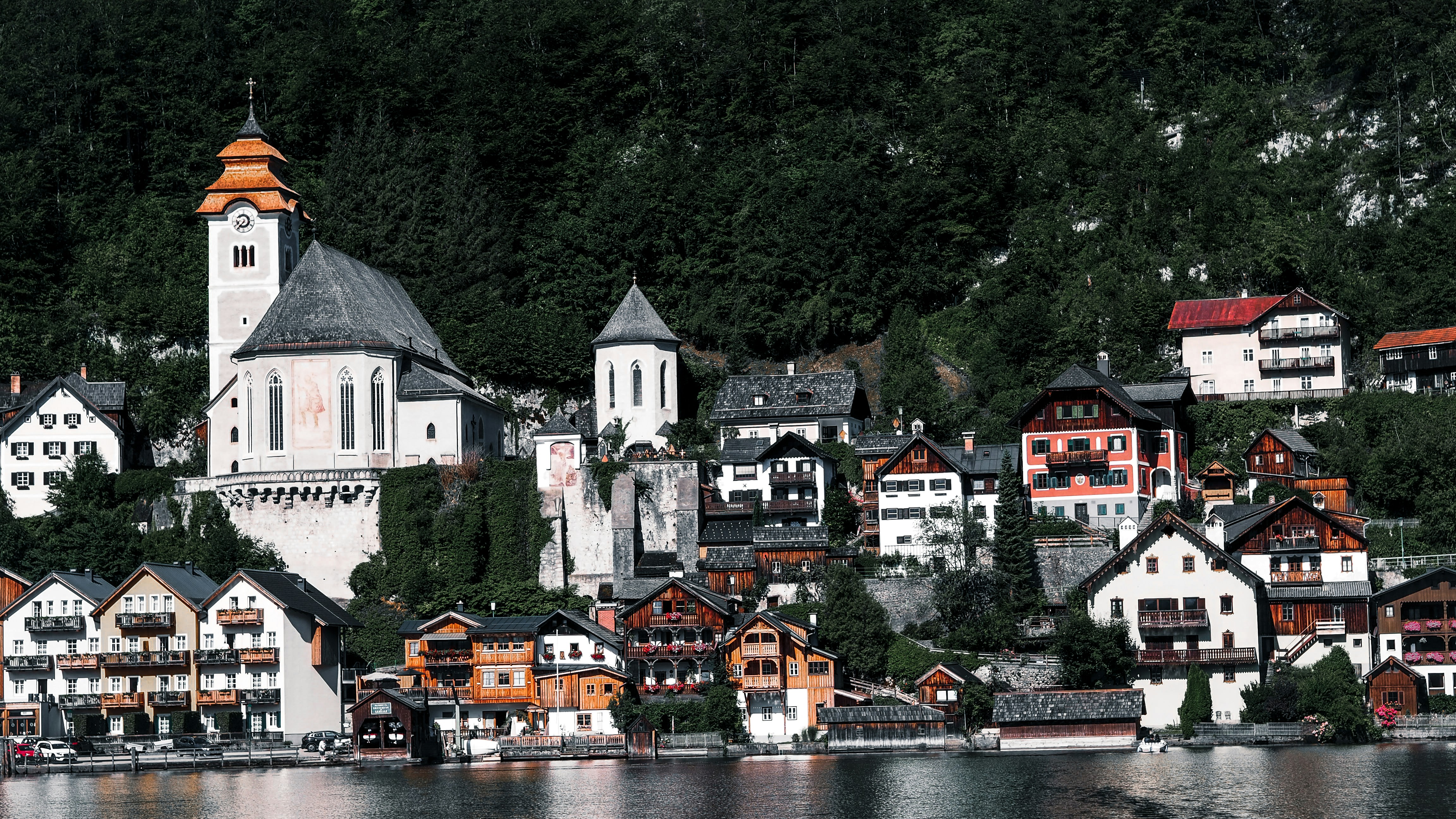white and brown concrete building near river during daytime