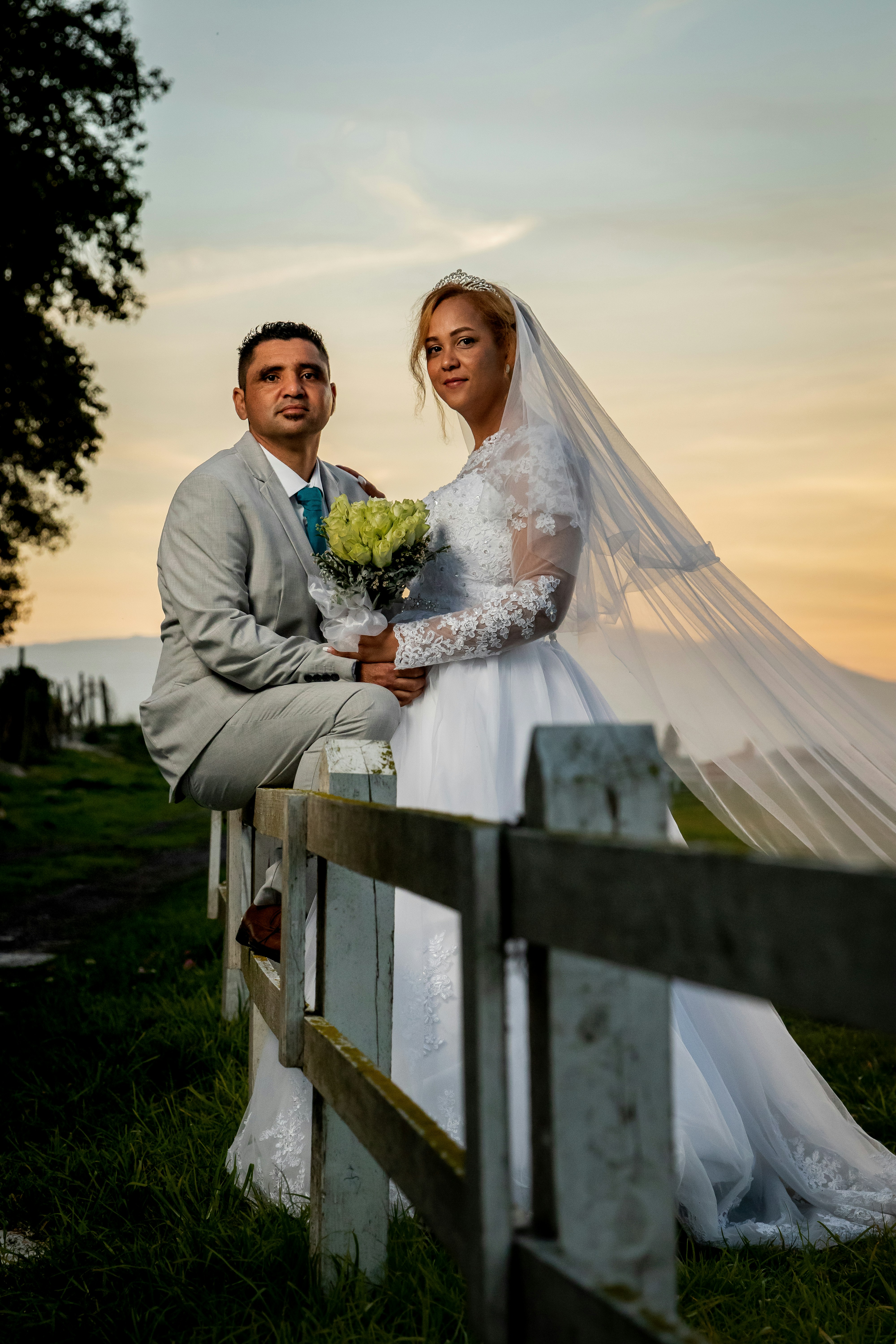 Man in gray suit jacket and woman in white wedding dress standing on green  grass field photo  Free Sunset Image on Unsplash