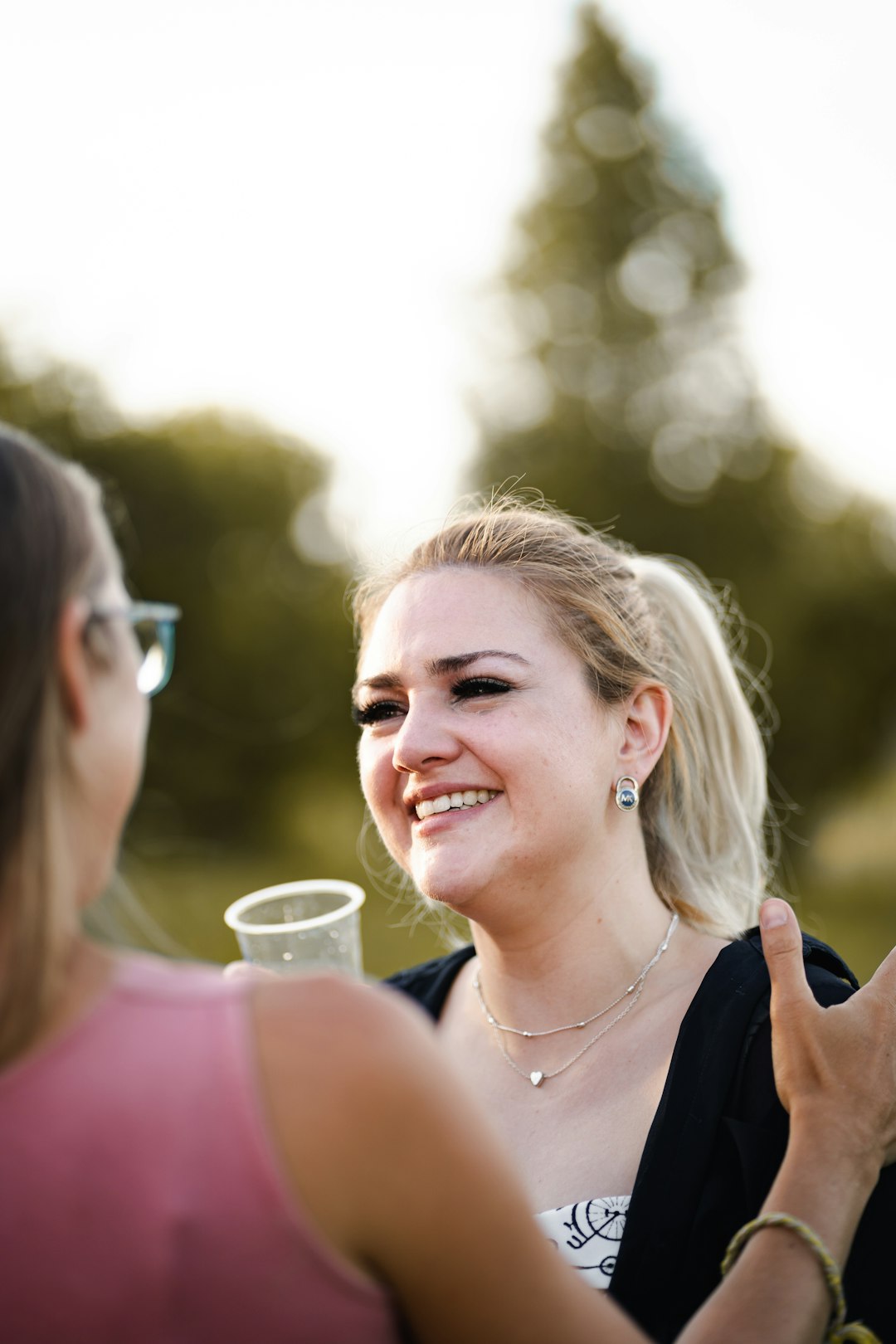 woman in black tank top smiling