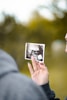 person holding picture of woman