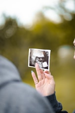 person holding picture of woman