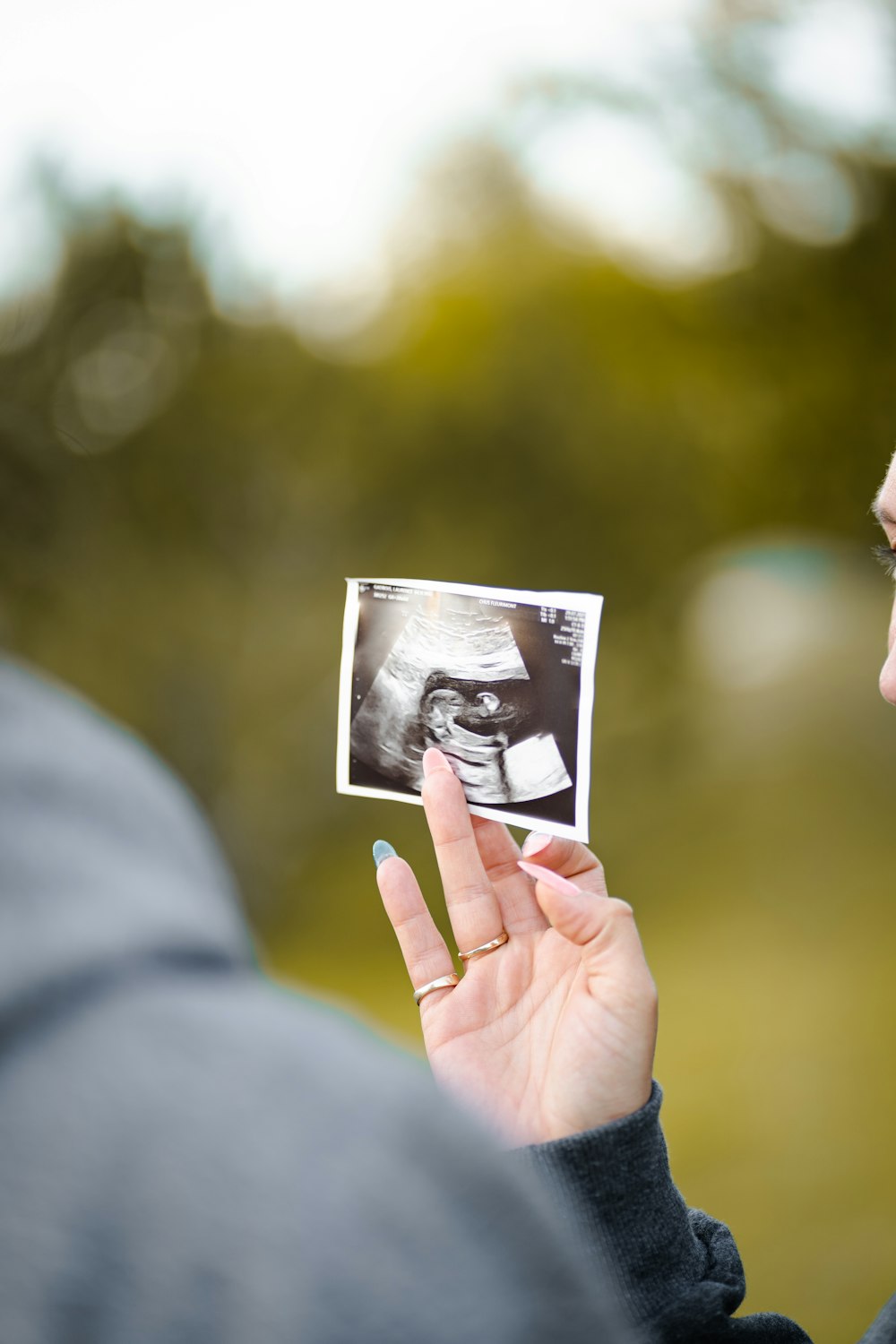 person holding picture of woman