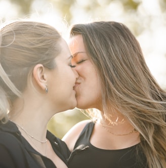 woman kissing womans cheek