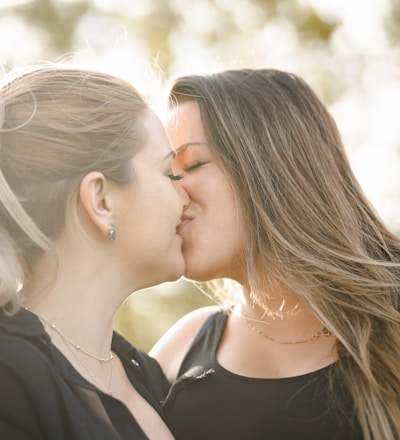 woman kissing womans cheek