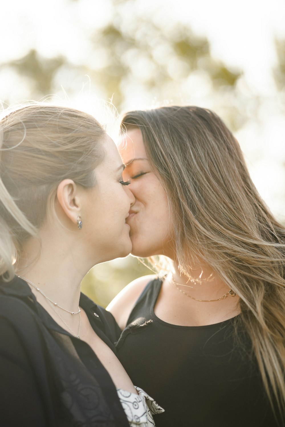 woman kissing womans cheek