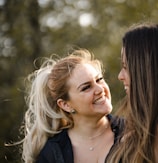 woman in black shirt smiling beside woman in black shirt