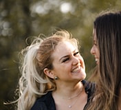 woman in black shirt smiling beside woman in black shirt