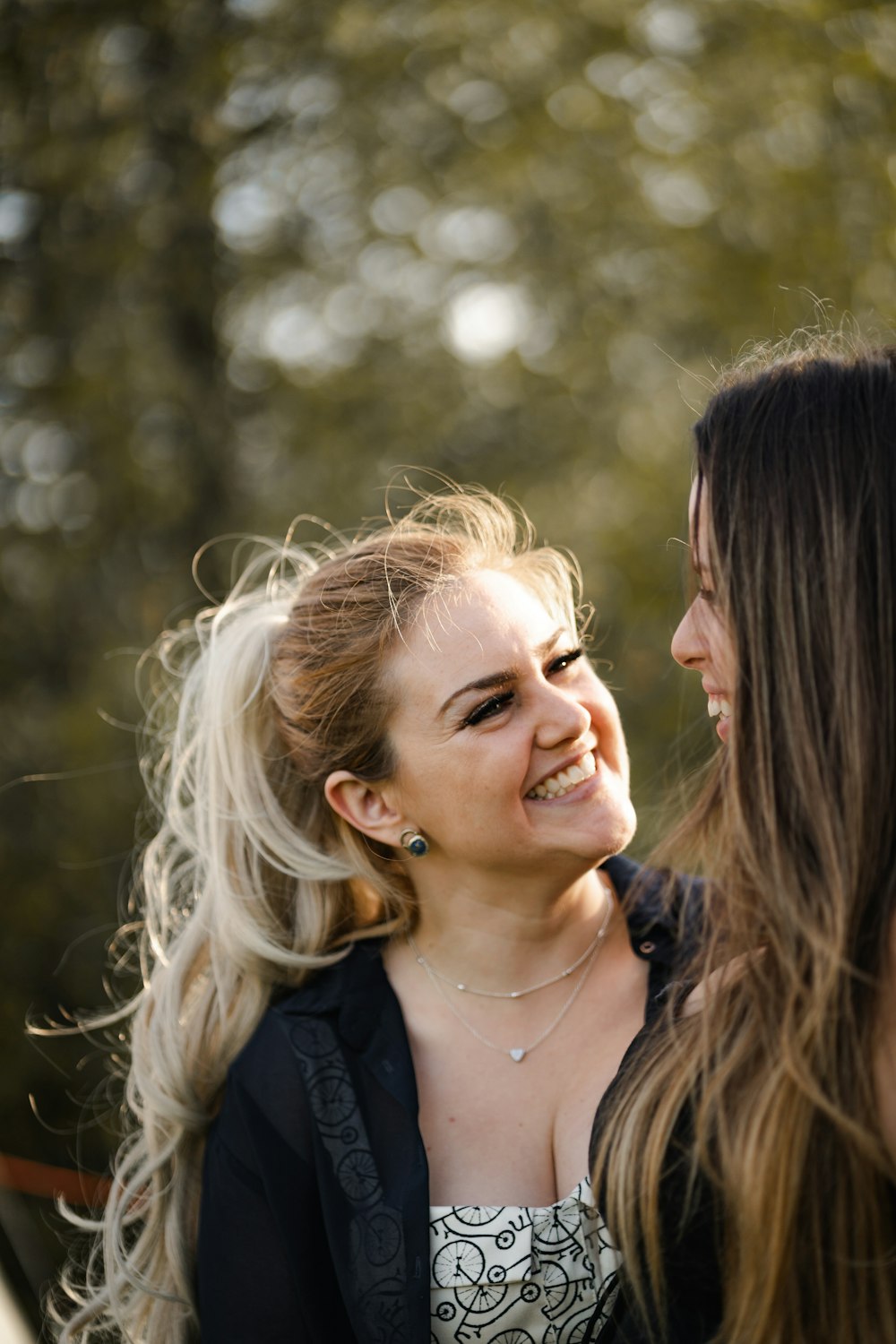 woman in black shirt smiling beside woman in black shirt